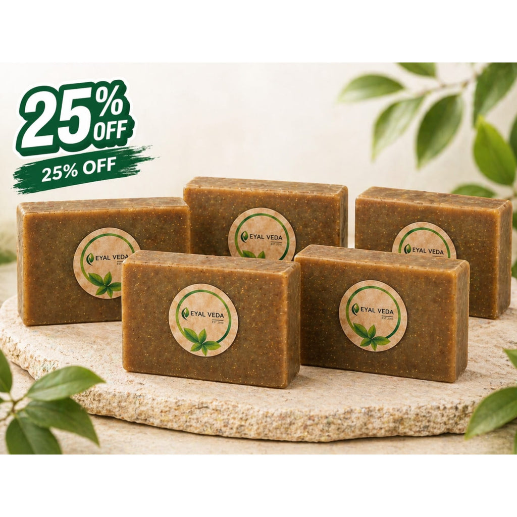 Five bars of soap with a '25% Off' label on a natural stone surface with green leaves in the background.